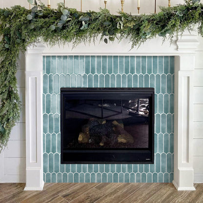 Fireplace with greenery above it in a home setting