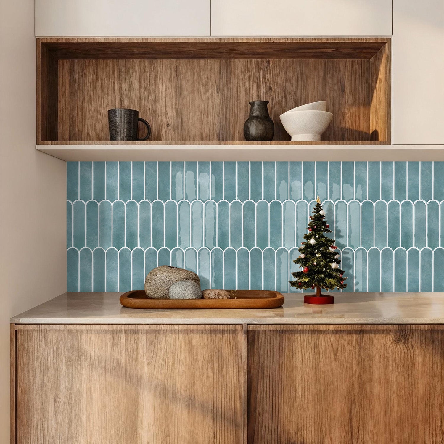 Kitchen interior with wooden cabinets, a blue tiled backsplash, and decorative items on a shelf.